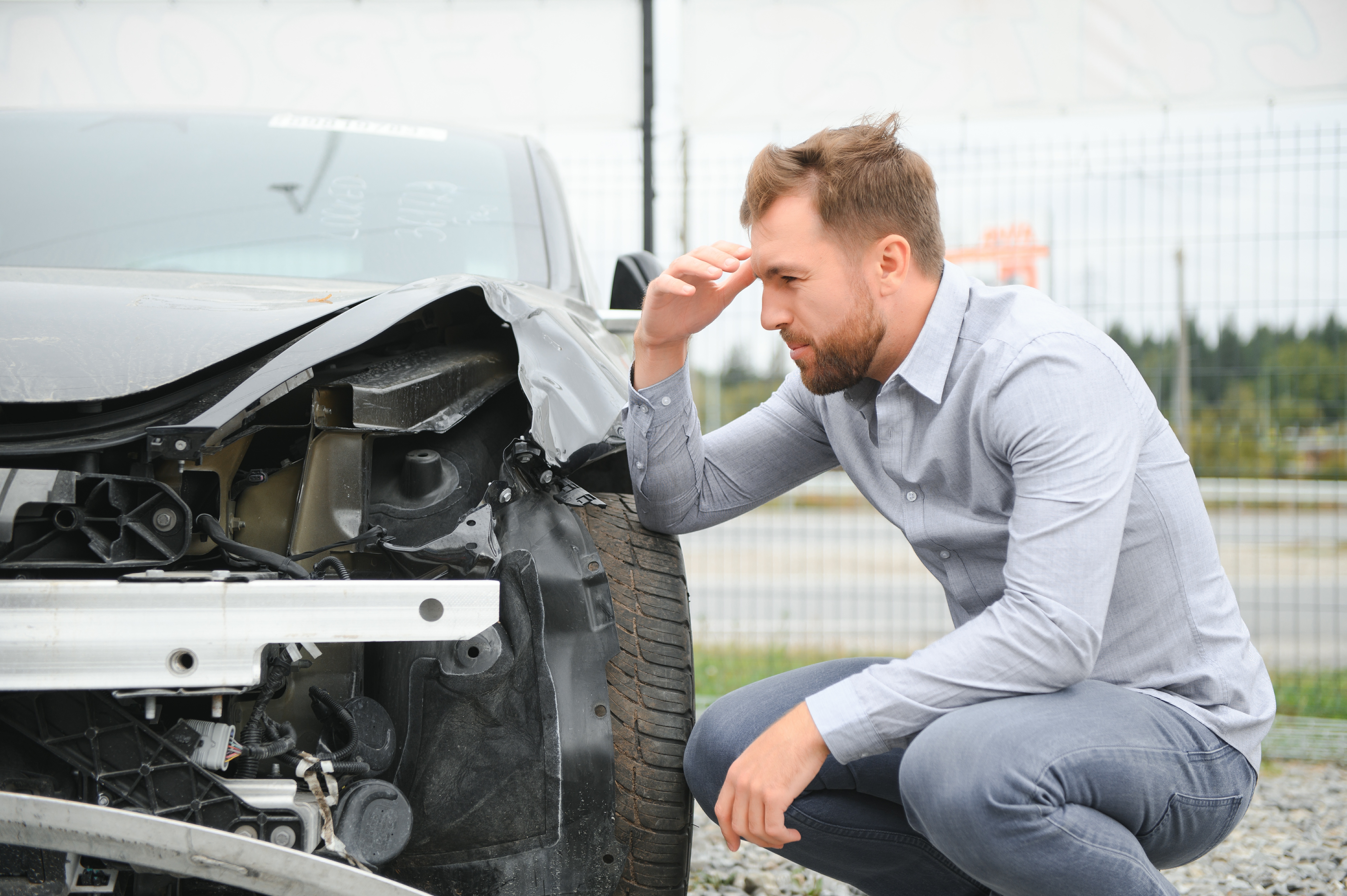 What to do after a car accident. A Man after car accident. Man regrets damage caused during car wreck.